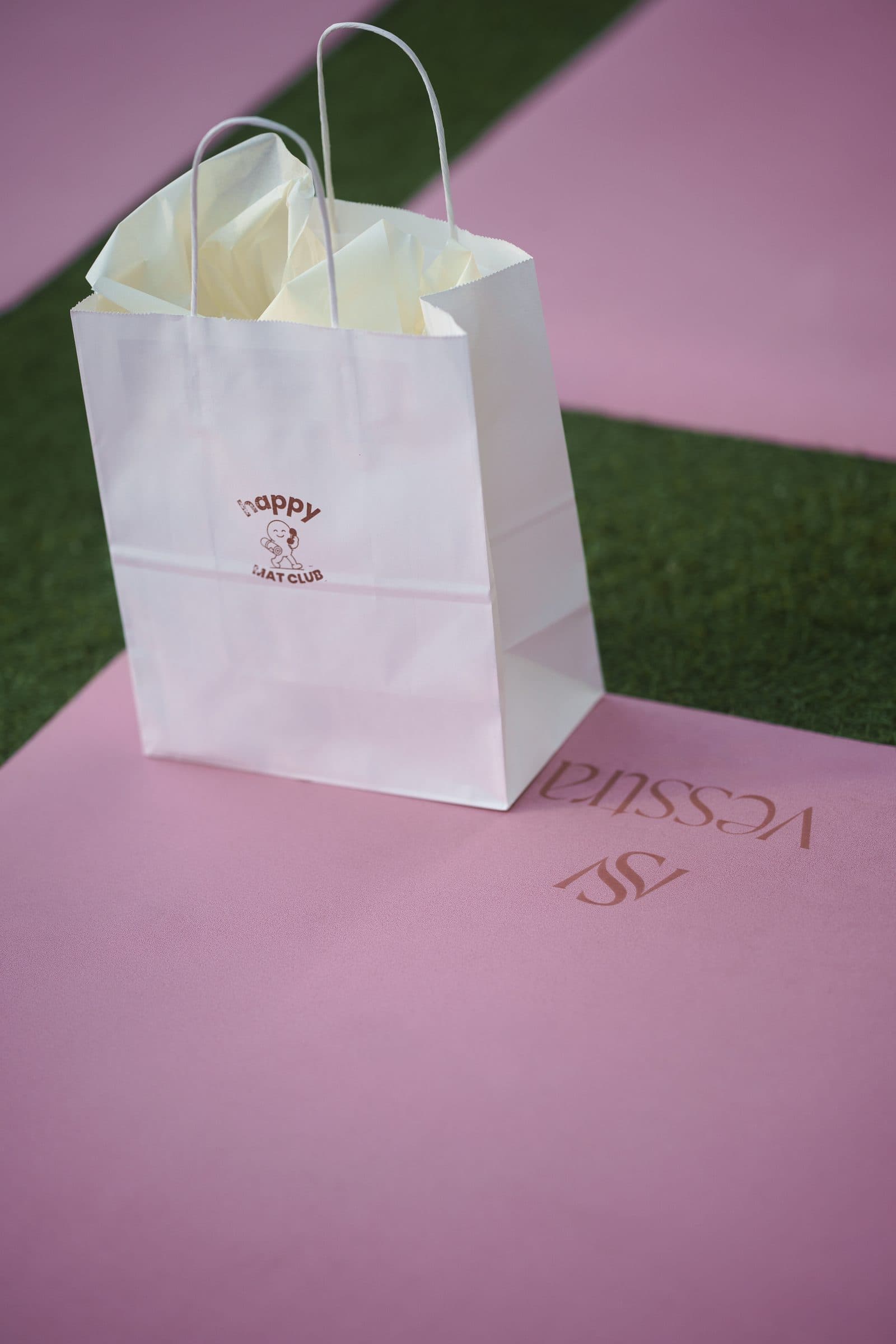 A Happy Mat Club bag waiting on a pink mat