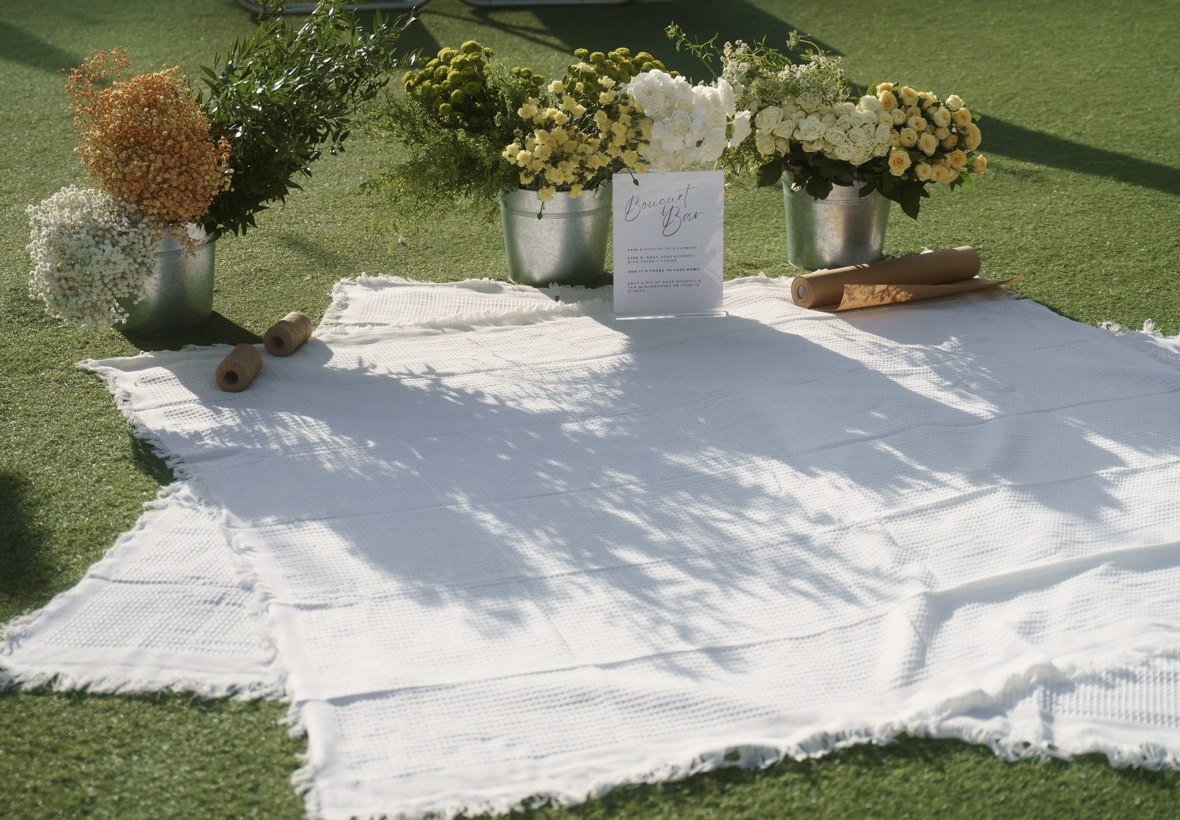Flowers and a blanket laid out on the grass
