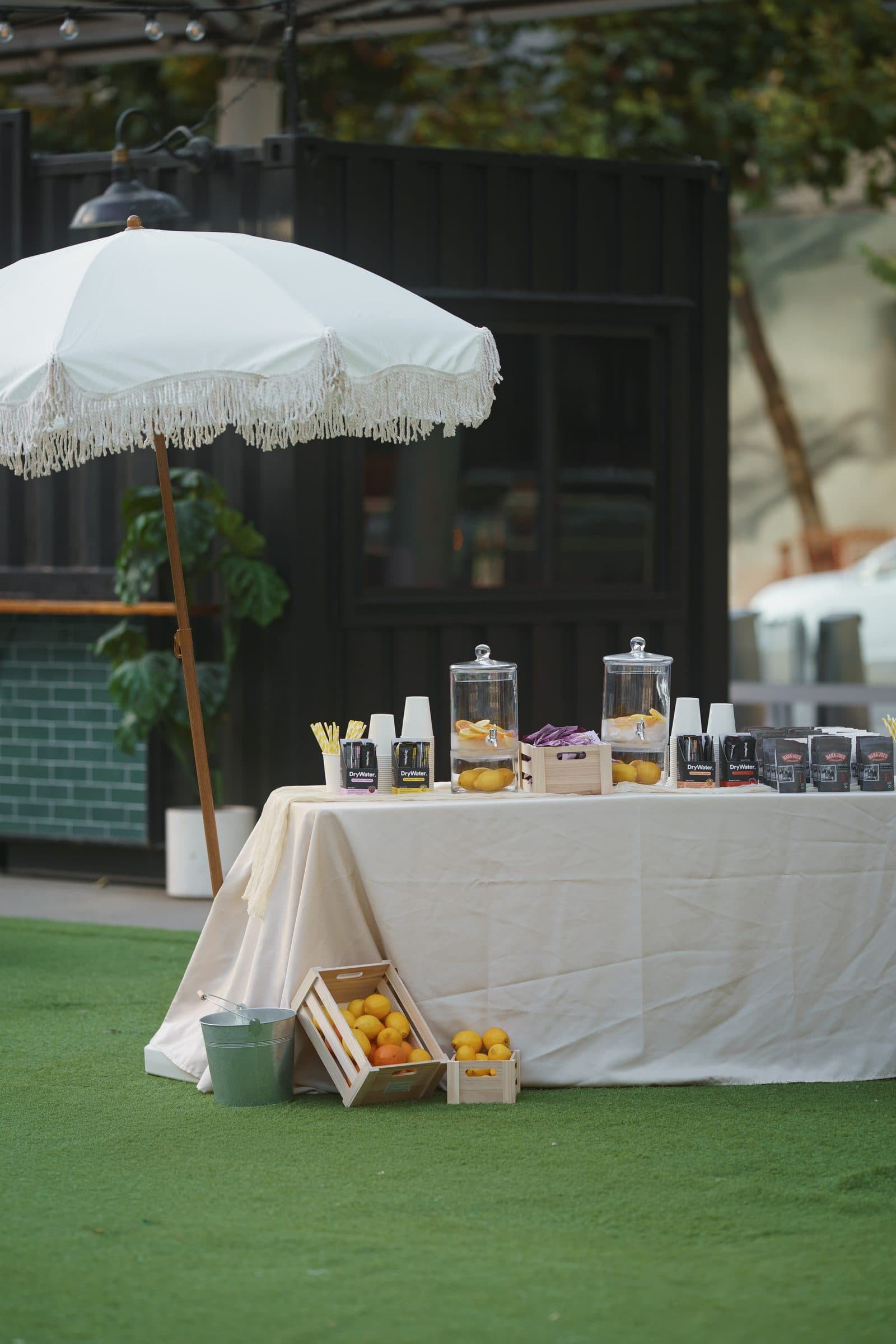 The refreshments table under a white umbrella